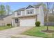 Beautiful home showcases a two-car garage, stone accents, and well-maintained landscaping at 9230 Avery Meadows Dr, Charlotte, NC 28216