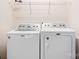 Well-equipped laundry room with white Maytag washer and dryer, providing convenience and efficiency at 9230 Avery Meadows Dr, Charlotte, NC 28216