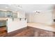 Open-concept living area with modern kitchen bar, wood floors, and carpeted living space, great for entertaining at 9230 Avery Meadows Dr, Charlotte, NC 28216