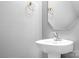 Cozy powder room featuring a modern sink, mirror, and brass fixtures, perfect for guests at 9230 Avery Meadows Dr, Charlotte, NC 28216