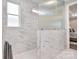 Walk-in shower with tile surround and glass door with a view into the bedroom at 9413 Liberty Hill Dr, Mint Hill, NC 28227