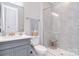 Modern bathroom with gray vanity, white countertop, and a spacious walk-in shower with tiled walls at 9413 Liberty Hill Dr, Mint Hill, NC 28227