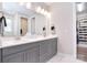 Ensuite bathroom features dual vanities, a closet, tile flooring, and modern lighting at 9413 Liberty Hill Dr, Mint Hill, NC 28227