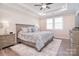 Comfortable bedroom with tray ceiling, ceiling fan, shutters, and an area rug at 9413 Liberty Hill Dr, Mint Hill, NC 28227
