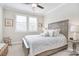 Bedroom features a ceiling fan, a rug, and a view of two windows with shutters at 9413 Liberty Hill Dr, Mint Hill, NC 28227