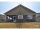 Back of home with screened porch, brick detail and well maintained lawn at 9413 Liberty Hill Dr, Mint Hill, NC 28227