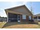 Back of home with screened porch, brick detail and well maintained lawn at 9413 Liberty Hill Dr, Mint Hill, NC 28227