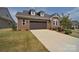 Attractive brick home with a two-car garage and long concrete driveway at 9413 Liberty Hill Dr, Mint Hill, NC 28227
