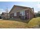 Back of home with screened porch, brick detail and well maintained lawn at 9413 Liberty Hill Dr, Mint Hill, NC 28227