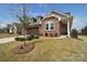 Charming brick home with well-manicured lawn and mature landscaping at 9413 Liberty Hill Dr, Mint Hill, NC 28227
