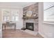 Charming stone fireplace with mantel, creating a cozy focal point at 9413 Liberty Hill Dr, Mint Hill, NC 28227