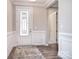 Elegant foyer with decorative glass door, wood floors, and wainscoting at 9413 Liberty Hill Dr, Mint Hill, NC 28227