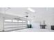 Spacious garage with ample storage, shelving, and a modern garage door at 9413 Liberty Hill Dr, Mint Hill, NC 28227
