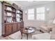 Dedicated home office features built-in bookshelves and a cozy seating area, ideal for work or study at 9413 Liberty Hill Dr, Mint Hill, NC 28227