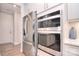 Close up of kitchen showcasing stainless steel fridge, double oven and quartz countertops at 9413 Liberty Hill Dr, Mint Hill, NC 28227