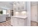 Butler's pantry featuring glass front cabinets, quartz countertop and beverage center at 9413 Liberty Hill Dr, Mint Hill, NC 28227