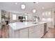 Open-concept kitchen showcases a large island with a sink, blending seamlessly into the living area with a fireplace at 9413 Liberty Hill Dr, Mint Hill, NC 28227