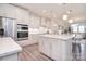Well-lit white kitchen offers stainless steel appliances and a large island perfect for dining or meal preparation at 9413 Liberty Hill Dr, Mint Hill, NC 28227