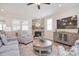 Cozy living room with a stone fireplace, plush seating, and modern decor at 9413 Liberty Hill Dr, Mint Hill, NC 28227