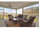 Inviting sunroom featuring comfortable seating, wicker furniture, and views of the backyard at 9413 Liberty Hill Dr, Mint Hill, NC 28227