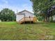 Exterior of a home with a wooden deck overlooking a well-maintained backyard at 1067 Old Charlotte Rd, Concord, NC 28027