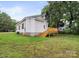 Side view of home featuring a wooden deck, and a well maintained lawn at 1067 Old Charlotte Rd, Concord, NC 28027