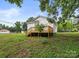 A view of the exterior of the home showcasing a wooden deck and a spacious backyard area at 1067 Old Charlotte Rd, Concord, NC 28027