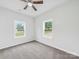 Bedroom featuring windows, neutral walls and floors and a ceiling fan at 1067 Old Charlotte Rd, Concord, NC 28027