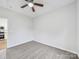 A bright bedroom featuring a fan, carpet, and a door leading to the kitchen at 1067 Old Charlotte Rd, Concord, NC 28027