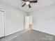 Comfortable bedroom with ceiling fan and a door leading to the hallway at 1067 Old Charlotte Rd, Concord, NC 28027