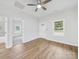 Bright living room with wood-look floors, ceiling fan, and natural light at 1067 Old Charlotte Rd, Concord, NC 28027