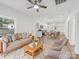 Open-concept living room and kitchen featuring neutral walls and wood flooring at 1067 Old Charlotte Rd, Concord, NC 28027