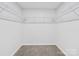 Spacious walk-in closet with carpet flooring and plenty of shelving at 1067 Old Charlotte Rd, Concord, NC 28027
