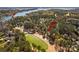 Aerial view of the property located on a golf course, close to a boat slip on the lake at 115 Brawley Harbor Pl, Mooresville, NC 28117