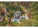 An aerial view showcases the property's lush landscaping, private pool, and surrounding greenery at 115 Brawley Harbor Pl, Mooresville, NC 28117