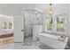 Spa-like bathroom with soaking tub, walk-in shower, marble finishes, and lots of natural light at 115 Brawley Harbor Pl, Mooresville, NC 28117
