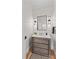 Powder room features shiplap walls, decorative lighting, a wooden vanity and marble countertop at 115 Brawley Harbor Pl, Mooresville, NC 28117