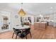 Dining area with pendant light fixture, view to kitchen and living room at 115 Brawley Harbor Pl, Mooresville, NC 28117