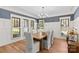 Bright dining room with modern chandelier, stylish chairs, and large windows at 115 Brawley Harbor Pl, Mooresville, NC 28117
