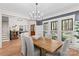 Open concept dining room with modern chandelier, stylish chairs and view to foyer at 115 Brawley Harbor Pl, Mooresville, NC 28117