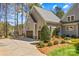 Charming home exterior with a side-entry garage, well-manicured landscaping, and mature trees at 115 Brawley Harbor Pl, Mooresville, NC 28117