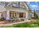 Charming front porch with seating area, complemented by well-manicured landscaping and a welcoming entrance at 115 Brawley Harbor Pl, Mooresville, NC 28117