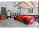 Immaculate garage featuring epoxy floors, cabinets, and a striking red sports car at 115 Brawley Harbor Pl, Mooresville, NC 28117
