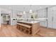 Bright kitchen with large island, bar stool seating, stainless appliances, and lots of natural light at 115 Brawley Harbor Pl, Mooresville, NC 28117