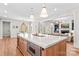 Kitchen island with a microwave, pendant lighting and a view to the living room with fireplace at 115 Brawley Harbor Pl, Mooresville, NC 28117