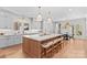 Open kitchen with large center island, seating, stainless appliances, and view to the dining area at 115 Brawley Harbor Pl, Mooresville, NC 28117