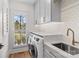 A bright laundry room featuring modern appliances, custom cabinets, and a stylish countertop at 115 Brawley Harbor Pl, Mooresville, NC 28117