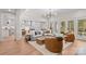 Spacious living room featuring hardwood floors with a view of the modern kitchen at 115 Brawley Harbor Pl, Mooresville, NC 28117