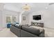 Spacious living room with a large sectional sofa, an elegant light fixture, and a TV at 115 Brawley Harbor Pl, Mooresville, NC 28117
