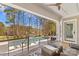 Covered outdoor living space overlooking a beautiful pool, golf course, and mature trees at 115 Brawley Harbor Pl, Mooresville, NC 28117